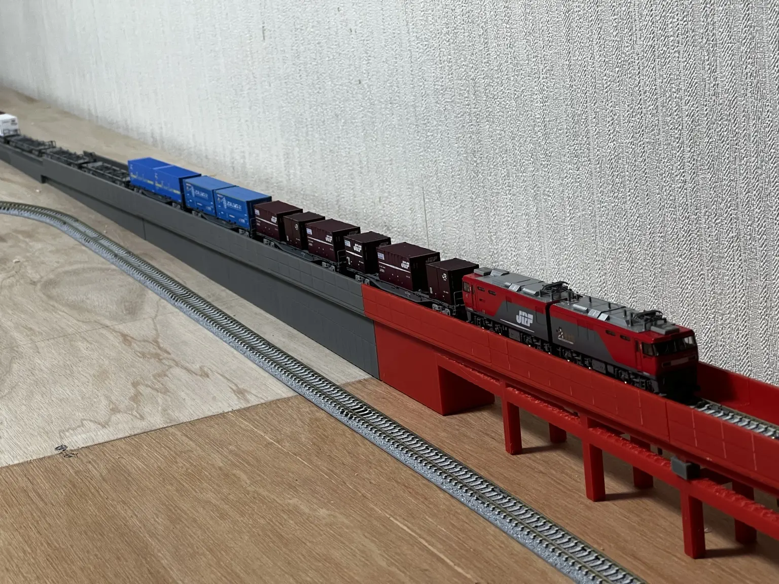 長くつながった高架線に貨物列車を載せて確認する様子